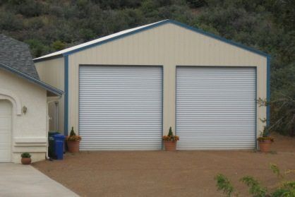 STEEL GARAGE NEXT TO HOUSE